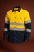 Yellow and navy work shirt with reflective stripes on a brown background
